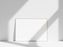 Empty frame on the white wall with window shadow photo