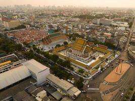 An aerial view of Red Giant Swing and Suthat Thepwararam Temple at sunset scene, The most famous tourist attraction in Bangkok, Thailand photo