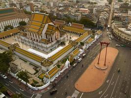 An aerial view of Red Giant Swing and Suthat Thepwararam Temple at sunset scene, The most famous tourist attraction in Bangkok, Thailand photo