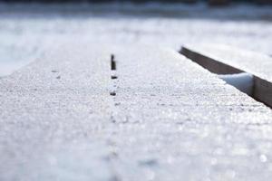 Fresh sparkling snow on a wooden palette photo