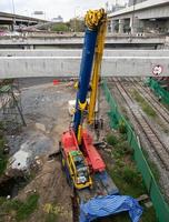 The large mobile crane with the long boom is ready to lift concrete beam. photo