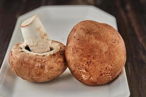 Portobello mushrooms on white plate in home kitchen photo