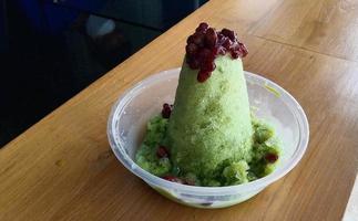 kakigori is Japanese shaved ice dessert , with red beans and sweet sauce on ice cream. Traditional summer dessert in Japan photo