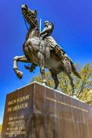 Washington, DC - Apr 3, 2021 -  Bronze sculpture larger than life statue of Simon Bolivar The Liberator on a marble pedestal with gold lettering. photo
