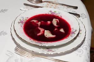 Red borscht with mushroom ravioli for christmas eve photo