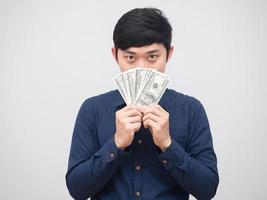 Asian man show money close his face on white background,Businessman close his face by dollar money photo