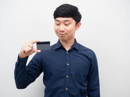 Man confident looking at credit card in his hand portrait photo