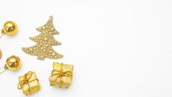 Close up golden christmas accessories on white background top view copy space photo