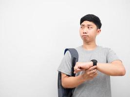 Asian man backpack with watch feeling worried copy space photo