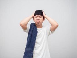 Man with towel feeling sleepy and headache unhappy face portrait white background photo