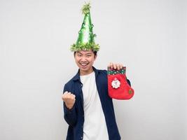 Man holding christmas stocking and show fist up for celebration merry christmas concept photo