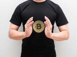 Golden bitcoin at space of man hand middle body on white isolated background photo