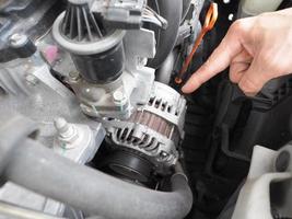 Hand point finger at engine of car unclean photo