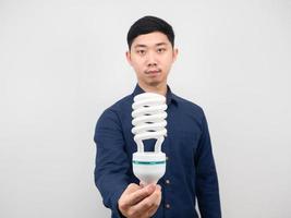 Asian man holding light bulb led in hand white background photo