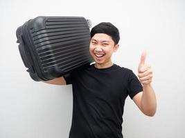 Man gesture carry luggage with smiling and thumb up photo