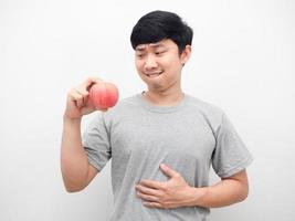 Asian man gesture hungry want to eatting rip apple in hand