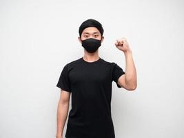 Man wearing mask confident show one fist up looking at camera white background photo