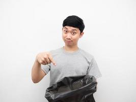 Man pointg finger at garbage in his hand white background photo