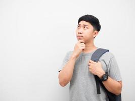 Man grey shirt with backpack gesture thinking copy space white background photo