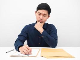 Man sitting at workplace with many document on the table thinking for something white background photo