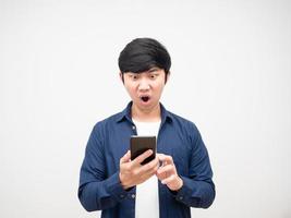 Asian man holding mobile phone and feeling shocked portrait white isolated photo