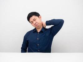 Man sitting touch his neck feeling tried from working photo