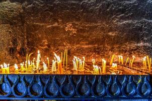 Lit candles burning in old Sevanavank church in Sevan,  Armenia. photo