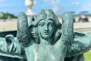 Statuette in the gardens of the famous Palace of Versailles in France. photo