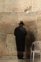Traditional Hassidic Man Praying at the Western Wall photo