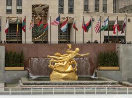 New York City - February 27, 2019 -  Prometheus Statue at Rockefeller Center in New York City in the winter with the ice skating rink. photo