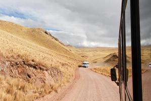 Tour bus along the Cusco-Puno Road, Peru photo