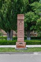 Khachkar in Holy Etchmiadzin Cathedral in Vagharshapat, Armenia. Khachkar, also known as an Armenian cross-stone, is a carved memorial stele bearing a cross, and often with additional motifs. photo