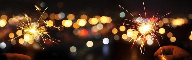 Happy New Year background with glowing sparklers. photo