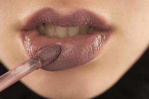 Makeup, lip makeup.Woman performs makeup, paints lips liner pencil photo