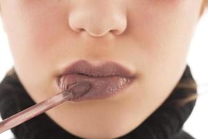 Makeup, lip makeup.Woman performs makeup, paints lips liner pencil photo