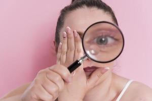 woman looking true magnifying glass photo