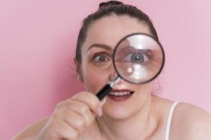 woman looking true magnifying glass photo