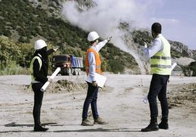 Surveyor engineer is measuring level on construction site. Surveyors ensure precise measurements before undertaking large construction projects. photo