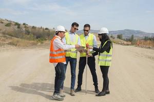 Surveyor engineer is measuring level on construction site. Surveyors ensure precise measurements before undertaking large construction projects. photo