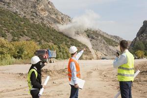 Surveyor engineer is measuring level on construction site. Surveyors ensure precise measurements before undertaking large construction projects. photo