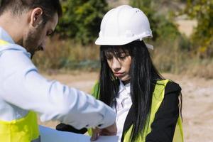 Surveyor engineer is measuring level on construction site. Surveyors ensure precise measurements before undertaking large construction projects. photo