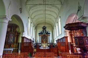 Church in the Medieval white houses in the Princely Beguinage Ten Wijngaerde in Bruges, Belgium, 2022 photo