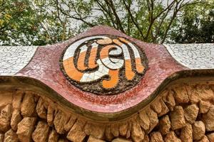 Wall along Park Guell in Barcelona, Spain. It is a public park system composed of gardens and architectonic elements located on Carmel Hill, in Barcelona, Catalonia photo