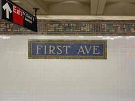 Brooklyn, New York - Apr 24, 2021 -  First Avenue Subway Station sign along 14th Street in Manhattan, New York City. photo