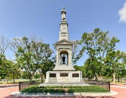 Dedicated in 1870, this Civil War Memorial depicts a soldier holding his rifle on top of the structure, while just below it is a bronze representation of Abraham Lincoln in Cambridge, Massachusetts. photo