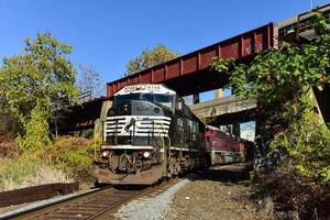 Freight train passing under bridge in Jersey City, New Jersey. photo