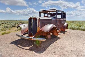 Route 66 vintage car relic displayed near the north entrance of Petrified Forest National Park in Arizona, USA, 2022 photo