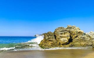 Big surfer waves and rocks at beach Puerto Escondido Mexico. photo