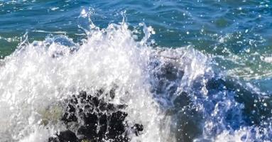 Big surfer waves and rocks at beach Puerto Escondido Mexico. photo