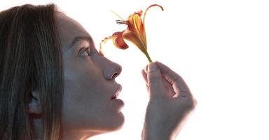 rtistic portrait of a female holding lily flower. Beauty concept.  isolated on white background photo